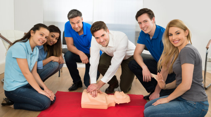 smiling people doing cpr training